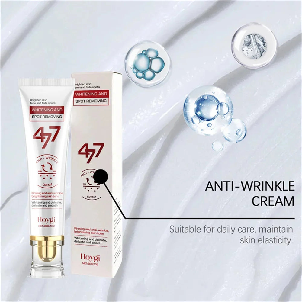 Hoygi spot-removing cream tube and box, white packaging with red text, set against a background of white cream swirls.