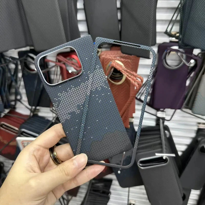Dark grey and blue geometric carbon fiber phone case with camera lens cutout, held in a hand.
