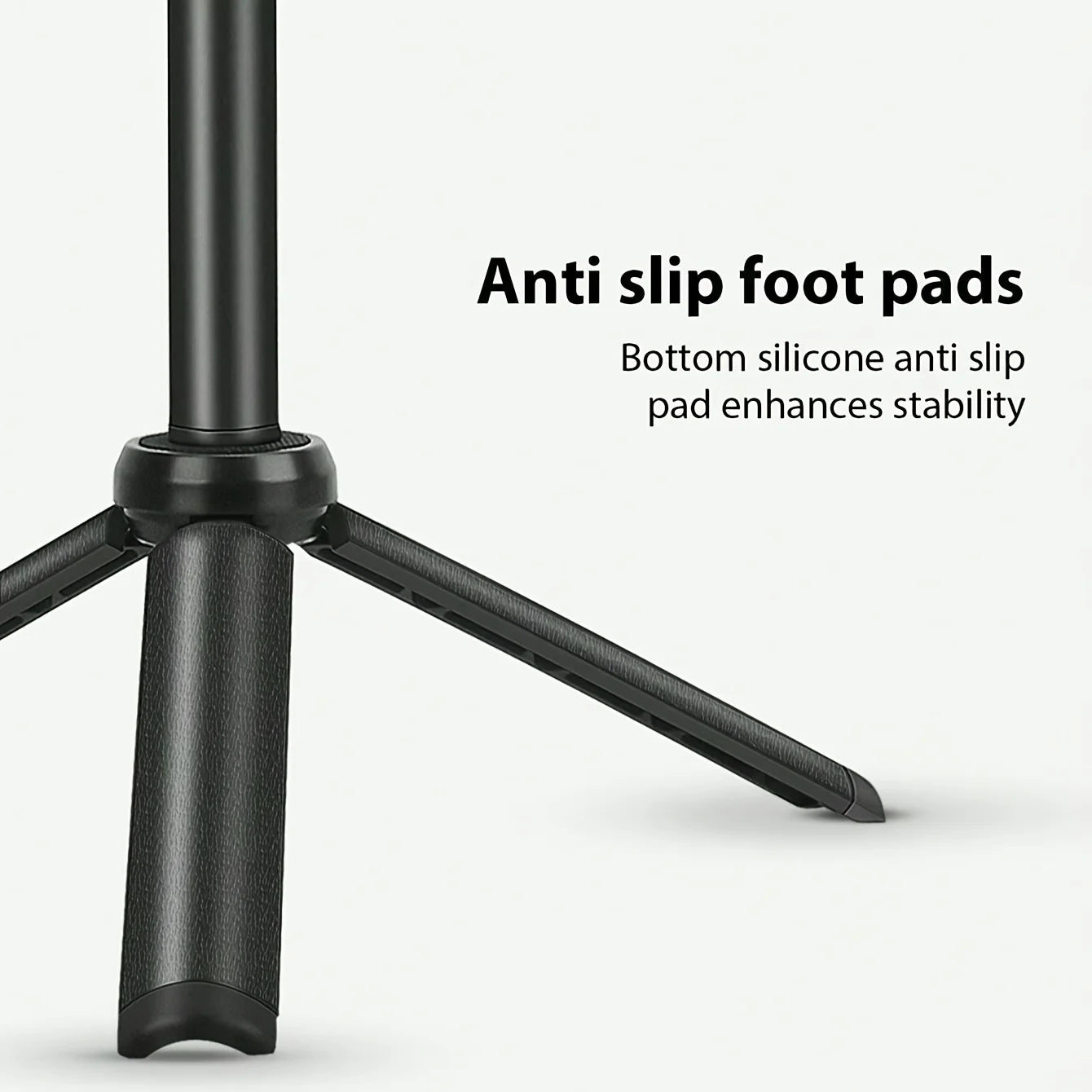 Black tripod base with textured legs and silicone anti-slip pads for stable positioning on flat surfaces.