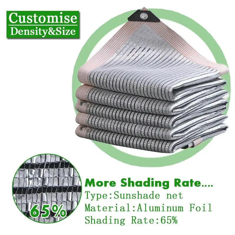 Silvery aluminum foil sunshade net, folded with grommets; 65% shading rate.