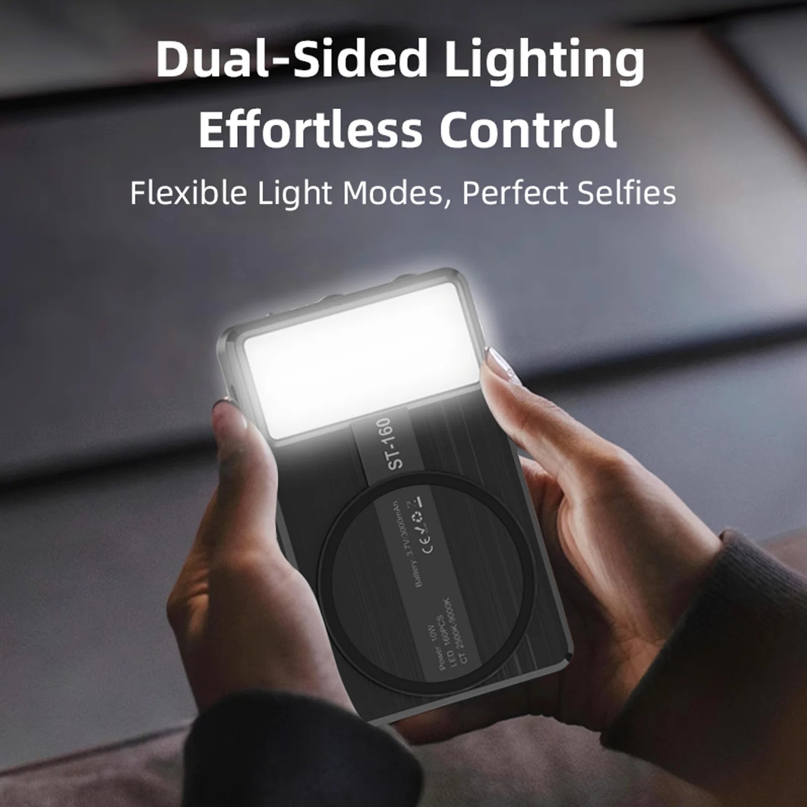 ST-160 black rectangular LED light with a circular magnetic back, held by hands, used for mobile photography lighting.