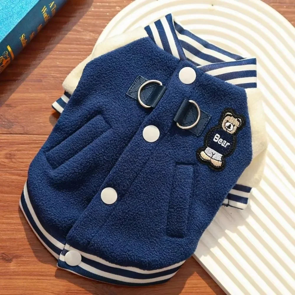 Blue fleece winter puppy baseball jacket with D-ring for leash, cute bear patch, and buttons for warm pet outdoor wear.