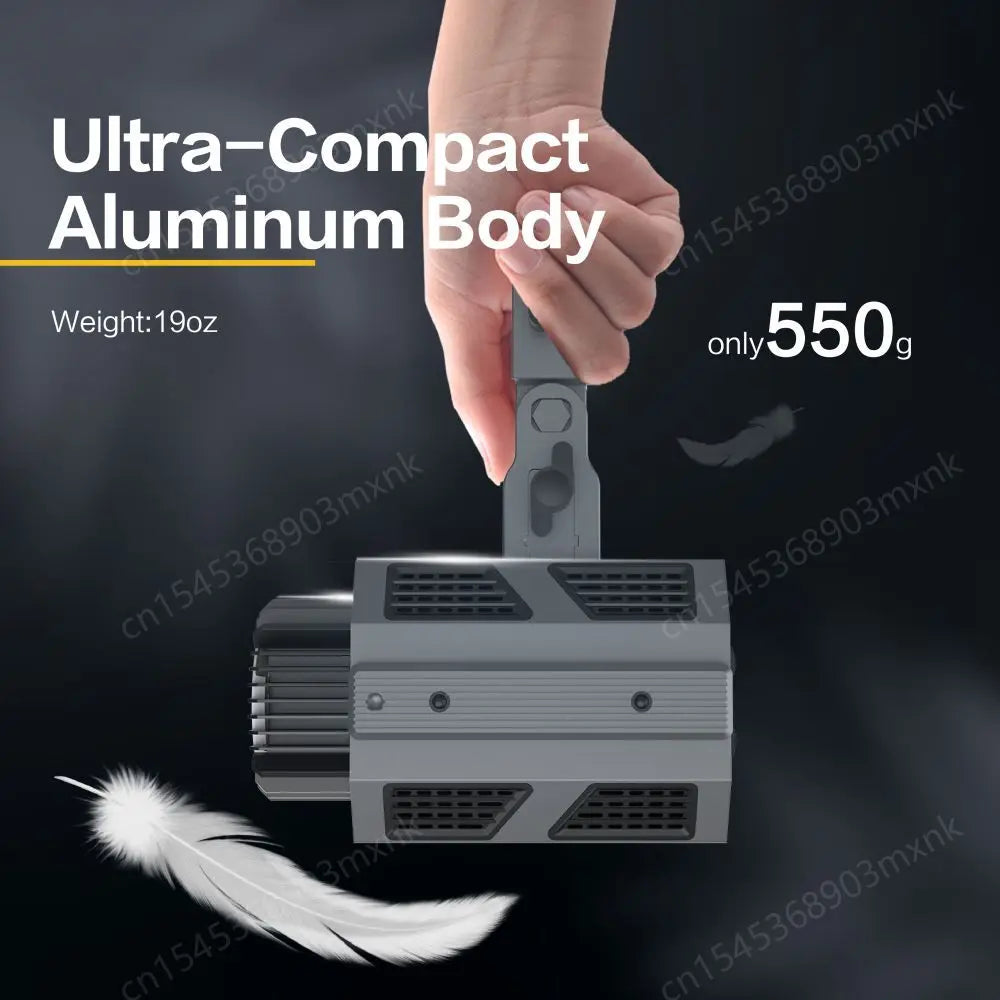 A gray, rectangular aluminum photography light held by its top handle, featuring side cooling vents.