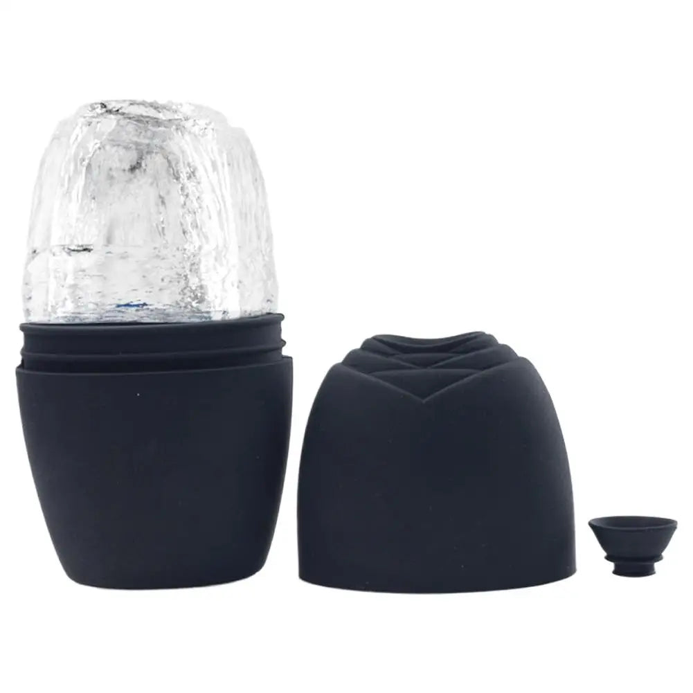Black silicone facial ice roller mold with a frozen ice cylinder, matching silicone cover, and small plug.