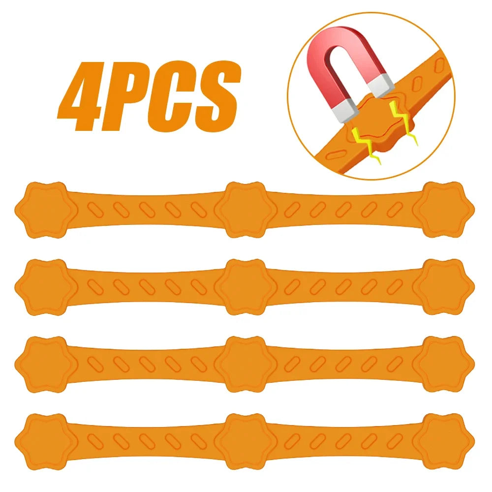 Four orange silicone magnetic air fryer parchment holder straps with star grips