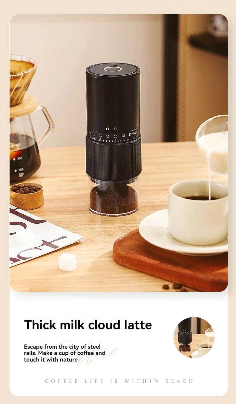 Black portable electric coffee grinder with adjustable burr settings and clear grounds container on a wooden table.