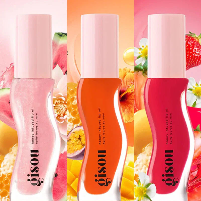 Gisou Honey Infused Lip Oil trio in pink, orange, and plum shades with a glossy, hydrating formula for plump lips.
