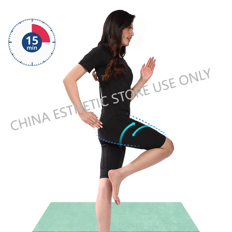 Woman wearing a black wireless EMS fitness suit for muscle training during a 15-minute home workout session.