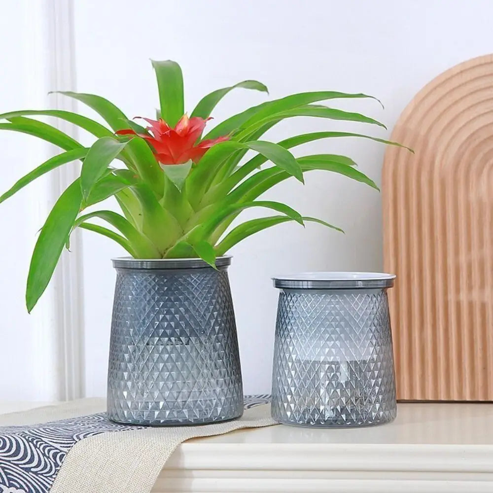 Self-watering plant pot pair in textured gray plastic with integrated water reservoir lids