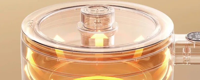 Clear glass lid on an electric cooking pot with steam vent opening