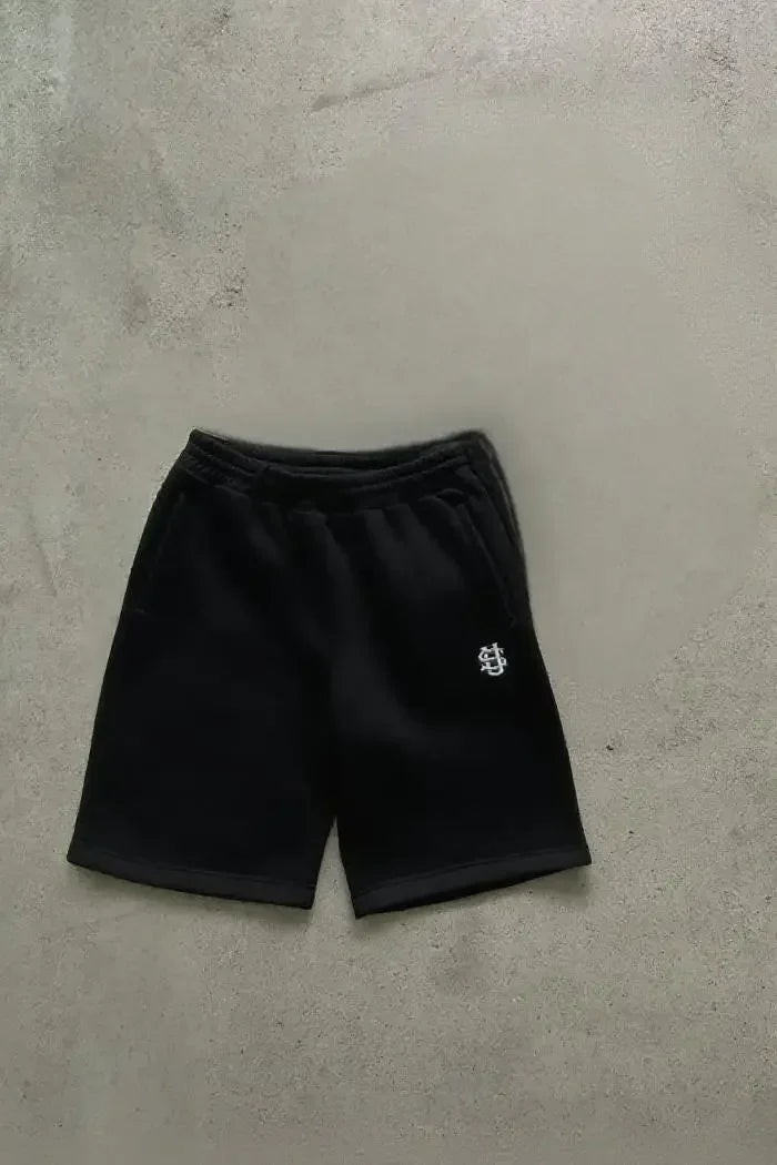 Tidesmit black cotton jogger shorts with an elastic waistband and a small white logo on the left leg.
