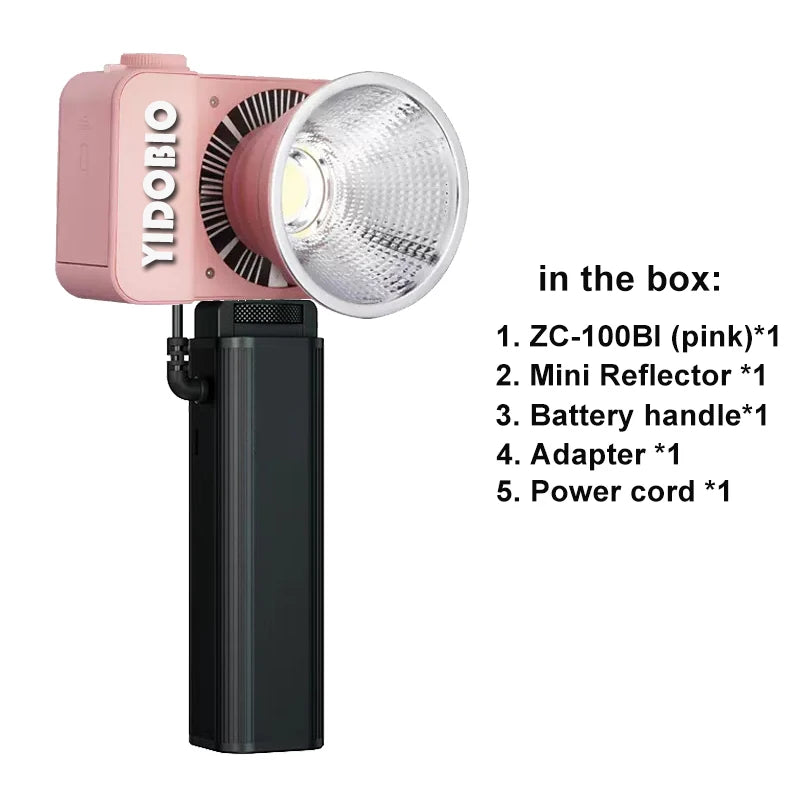 Pink ZC-100BI portable LED video light with a silver reflector and black battery handle for handheld photography.