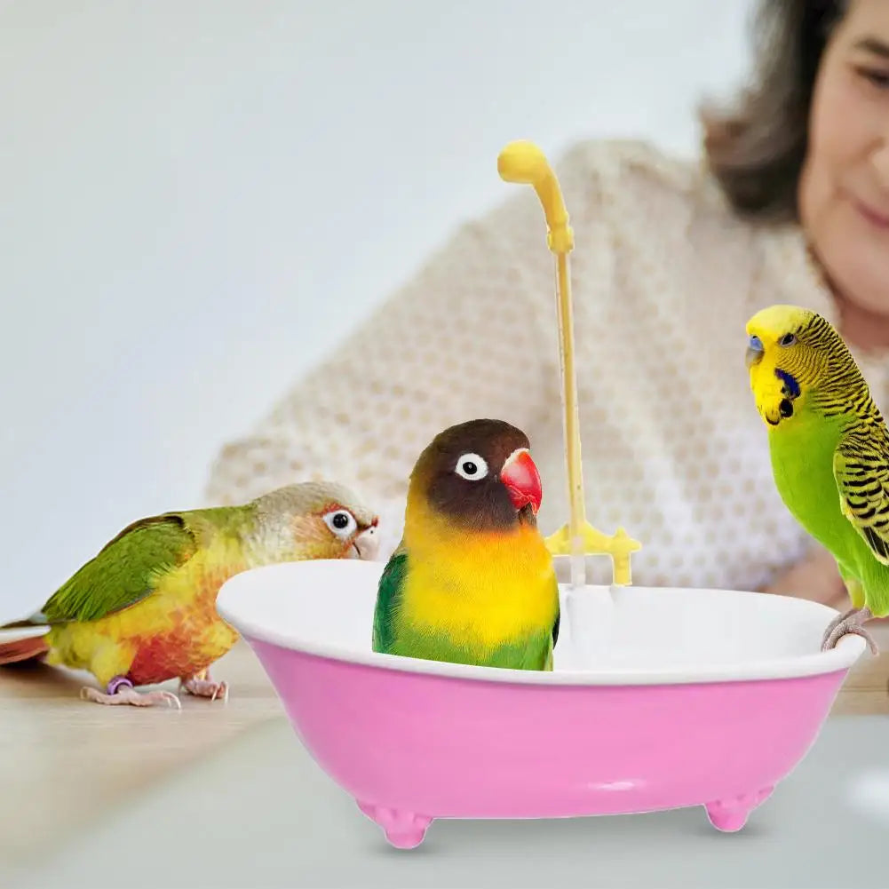 Automatic pink plastic bird bathtub with shower for parrots and parakeets to keep pet birds clean and entertained.