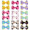 Colorful polka dot hair bow clips for small dogs and cats, perfect for stylish pet grooming and hair styling.