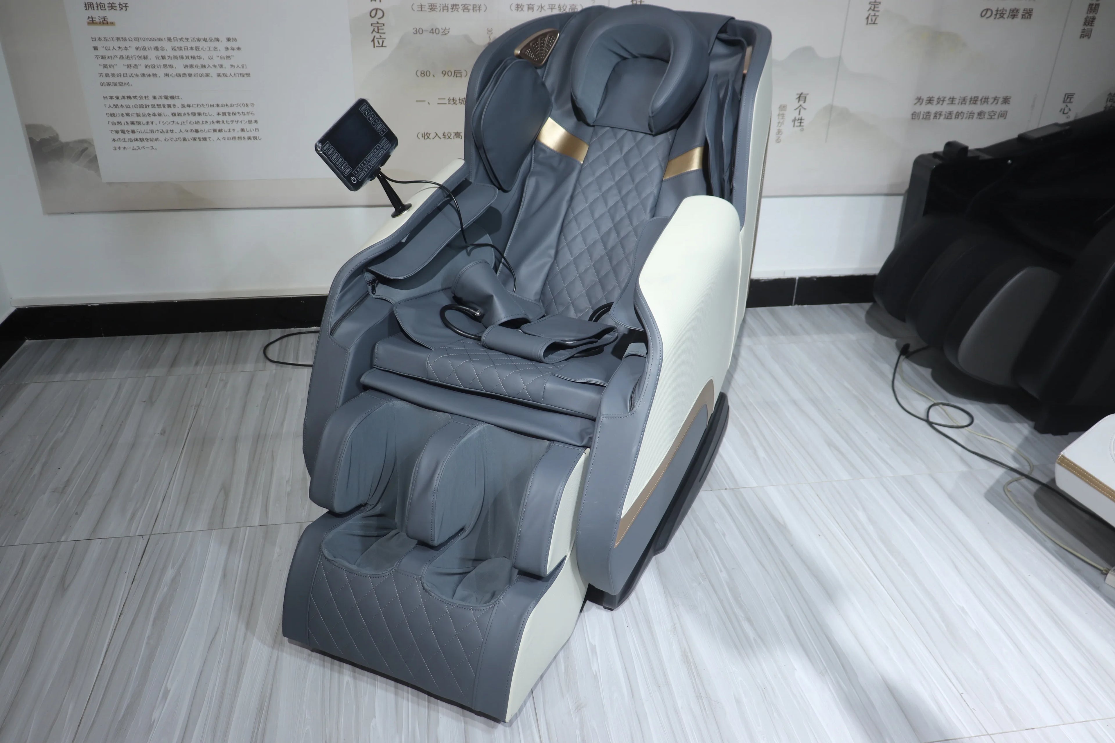Gray and white shiatsu massage chair with side massage rollers and extended leg support