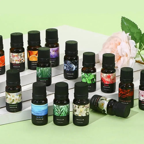 Set of aromatherapy essential oil amber glass bottles with floral and plant labels for natural wellness and relaxation.