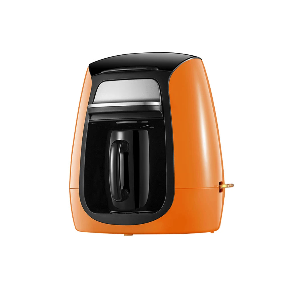 Orange compact single-serve coffee maker with black accents and a matching black mug on a white background.