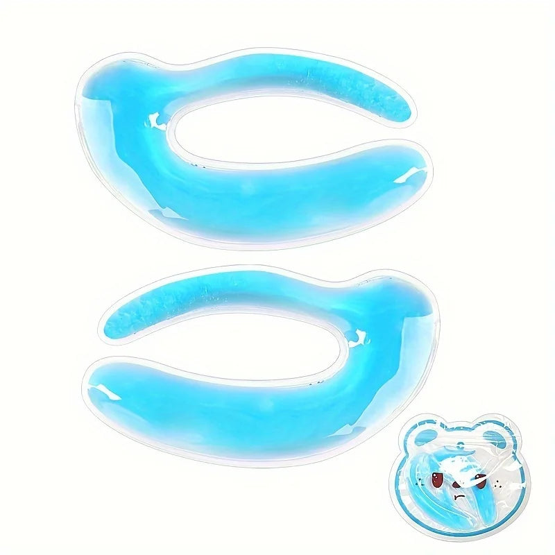 Two curved, blue gel-filled eye patches with a clear plastic seal, plus a small bear-shaped blue cooling pack.