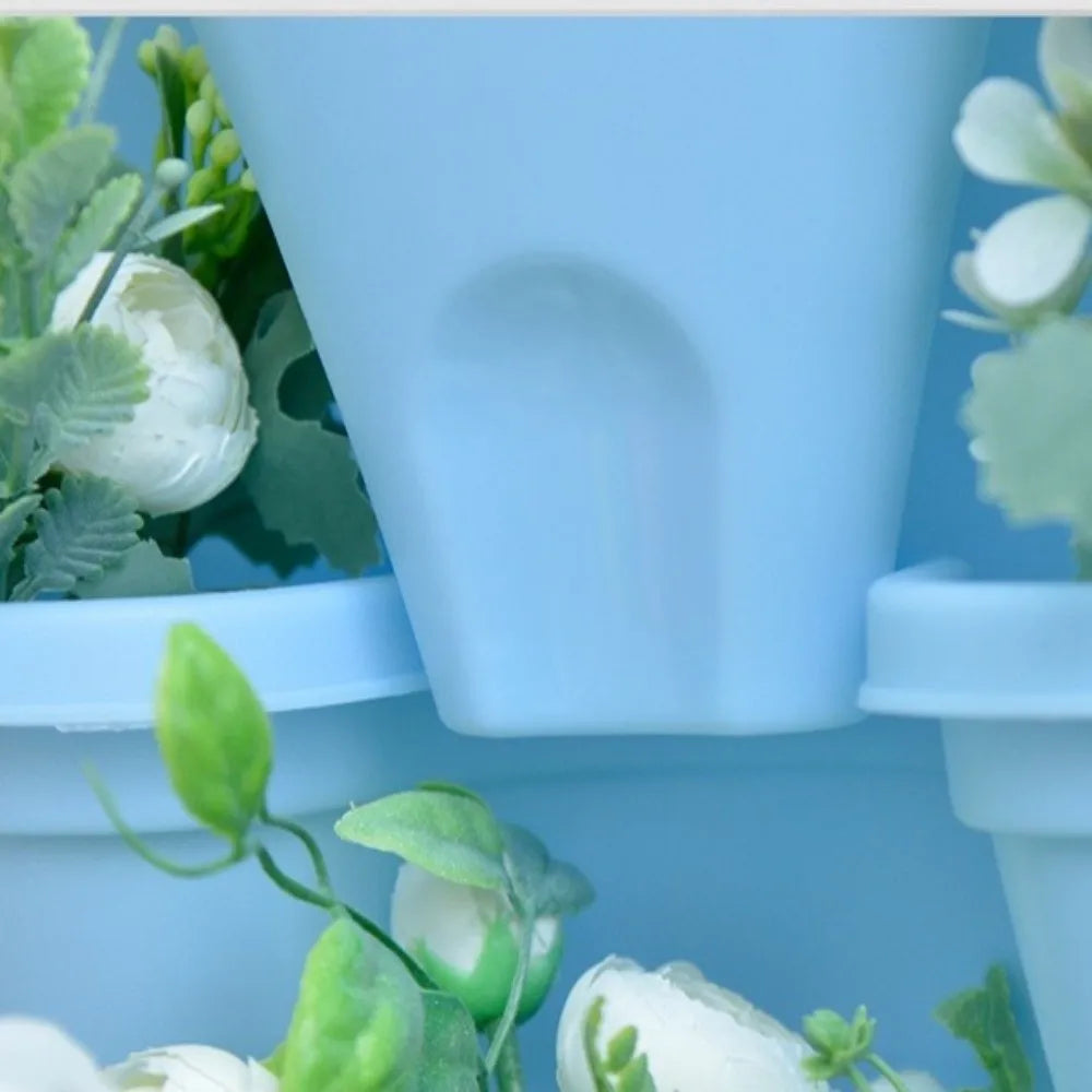 Green 4-petal plastic planter with central black drainage insert, front view of compartments
