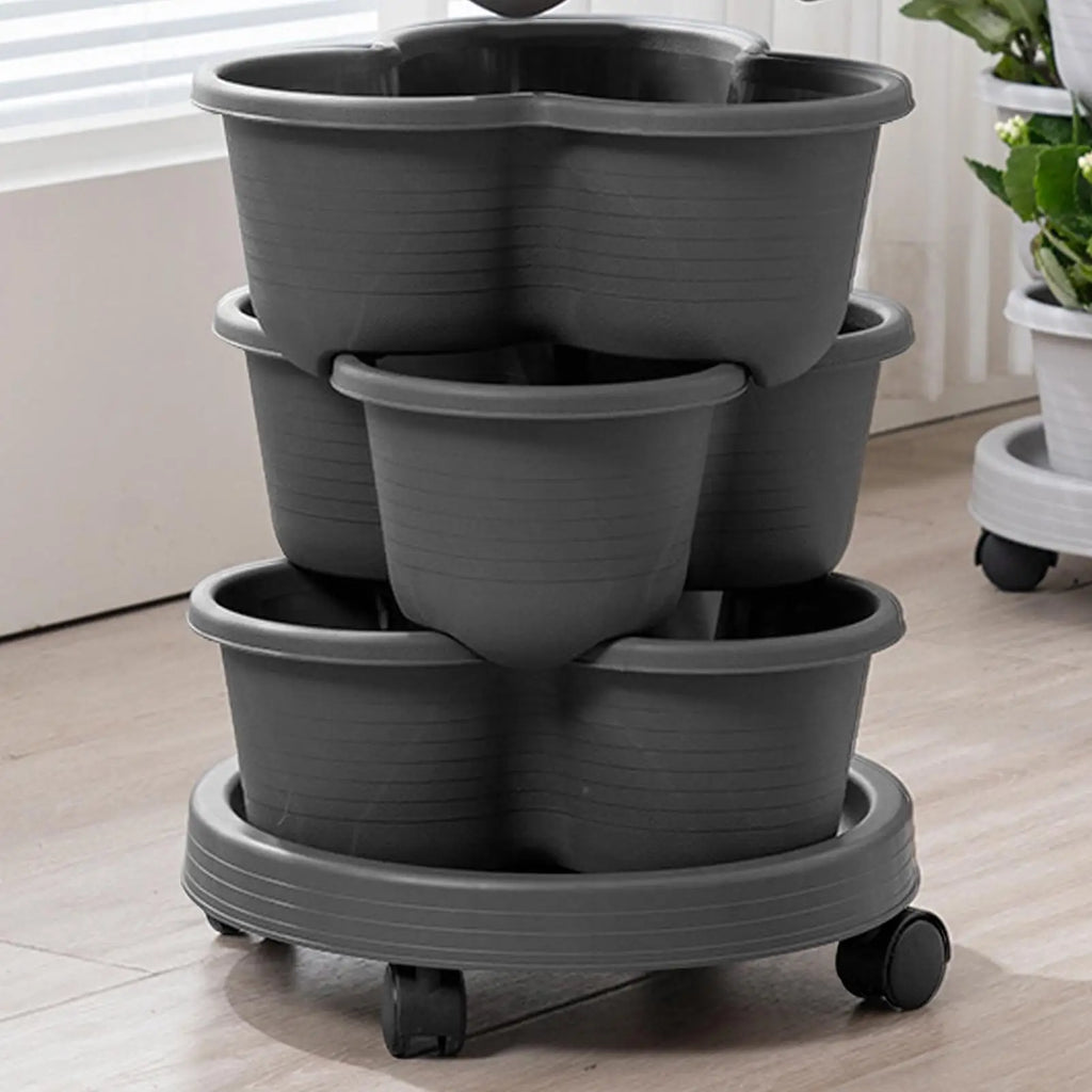 Dark grey stackable tiered planter tower with three pots and rolling wheels base.