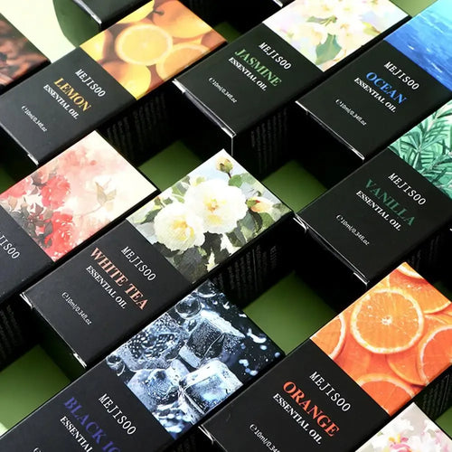 Collection of Mejisoo essential oil bottles in black boxes with various scents for aromatherapy and home wellness.