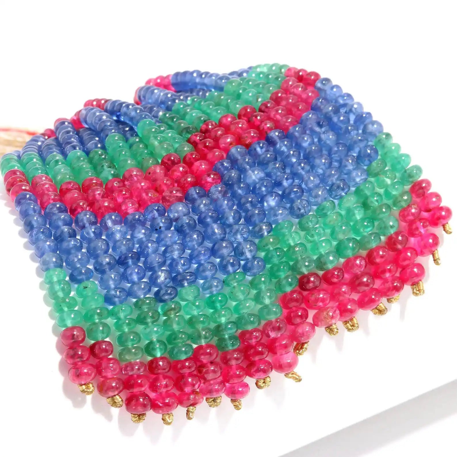 Multicolor gemstone bead strand with 4mm smooth rondelle beads in blue, green, and pink.