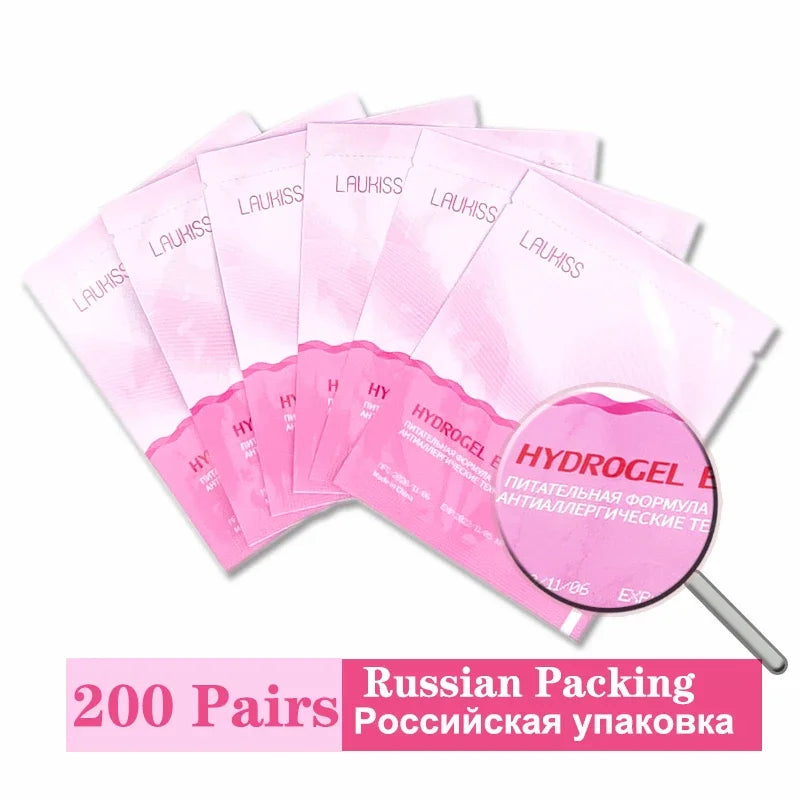 Pink Laukiss hydrogel under-eye patches for lash extensions in individual sealed packets for easy application.