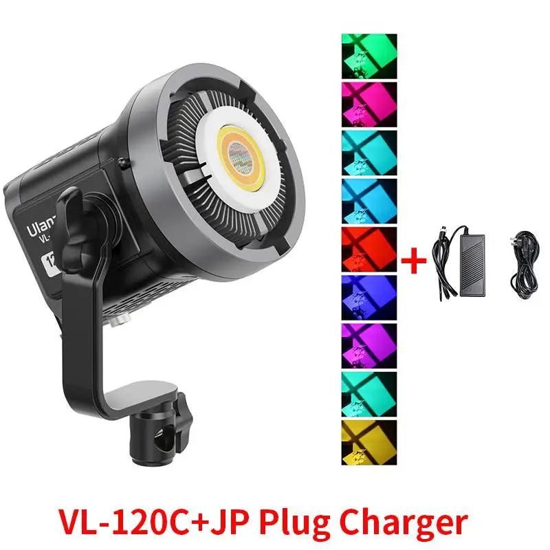 Black VL-120C LED studio video light with COB chip, mounting bracket, power adapter, and multicolored lighting options.