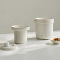 Mini electric rice cooker, smart white ceramic non-stick pot with lid, compact 600ml