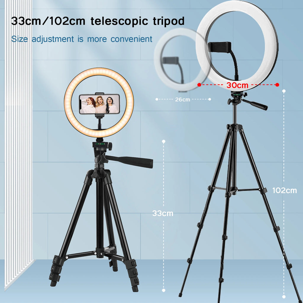A 30cm circular LED ring light on a black telescopic tripod with a phone mount for photography and video recording.