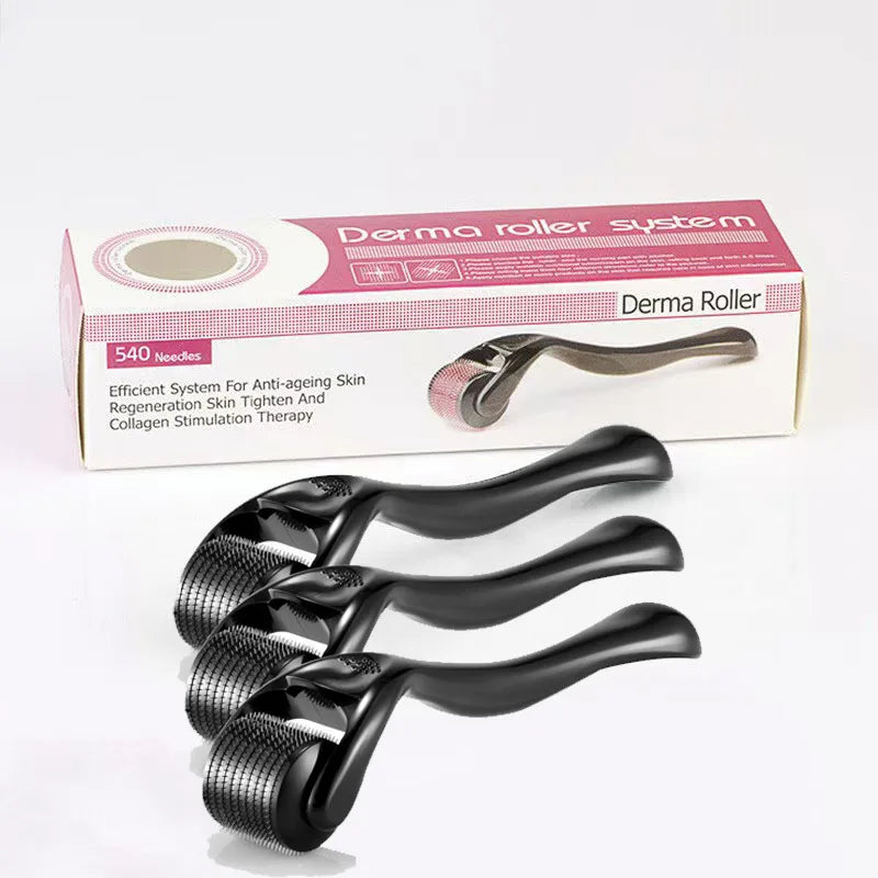 Three black 540-needle derma rollers placed in front of their pink and white product packaging box.