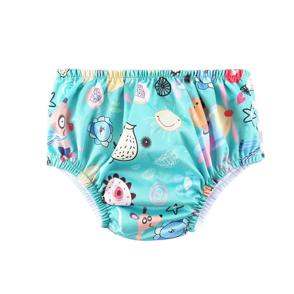 Reusable baby swim diaper in teal with colorful animal and sun pattern. Comfortable elastic fit for swimming.