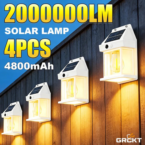 Four white solar wall lamps with sloped solar panels and warm-glowing tungsten bulbs mounted on a wooden fence.