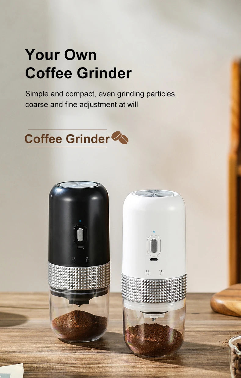Black and white portable electric coffee grinders with silver textured grips and clear catch bins on wood table.