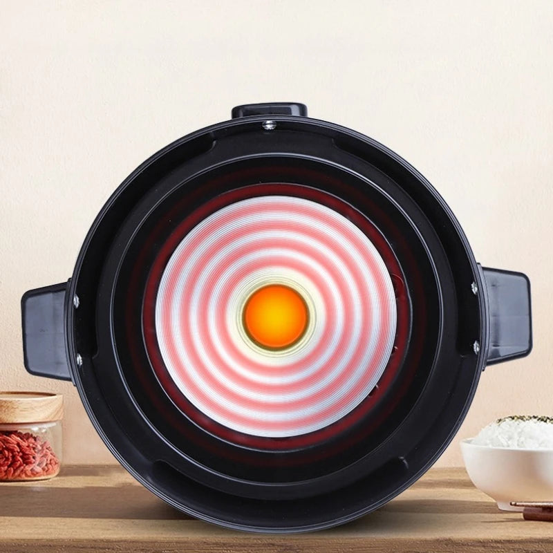 Mini rice cooker heating plate view from underside with glowing red inner coil