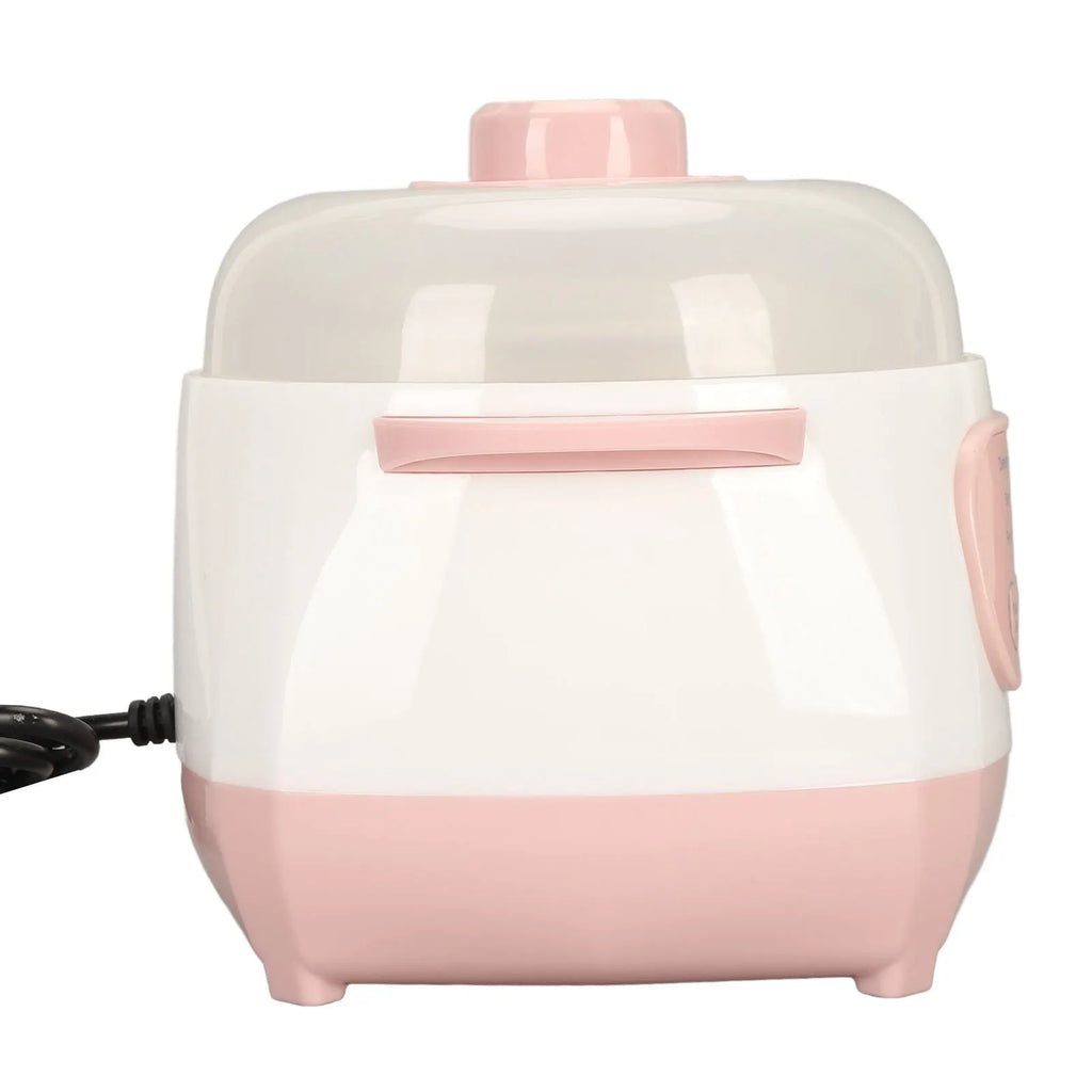 Pink and white mini electric rice cooker with clear lid and side handle, front view
