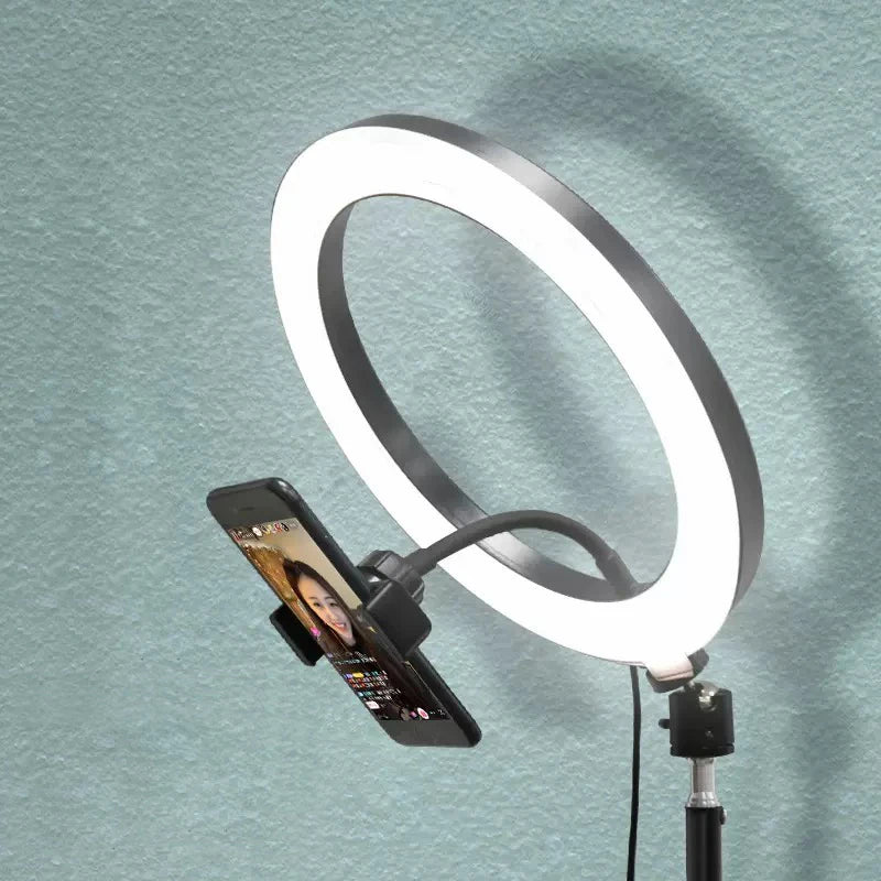 Black LED ring light with a flexible smartphone mount on a stand for photography and video streaming.