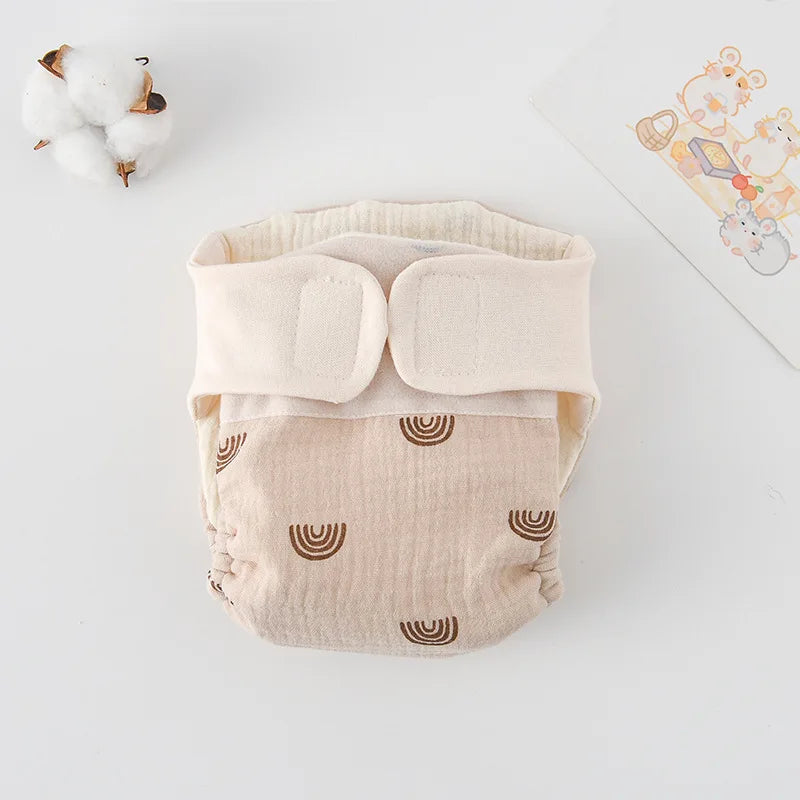 Beige baby cloth diaper with brown rainbow print and cotton fabric. Reusable infant baby care diaper.
