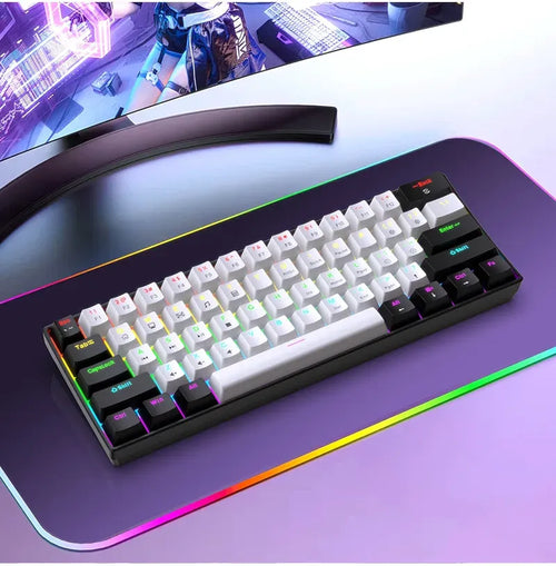 Ultra-compact 61-key mechanical gaming keyboard with RGB backlighting, white and black keycaps, on a glowing desk mat.