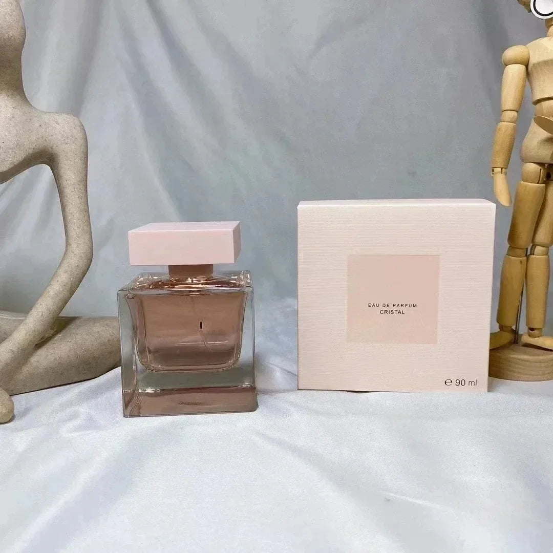 Cristal Eau de Parfum for women: 90ml woody floral musk scent in a square glass bottle with a pink cap and gift box.