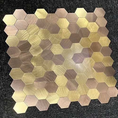 Peel-and-stick hexagon mosaic wall tiles in mixed gold, tan, and gray metallic