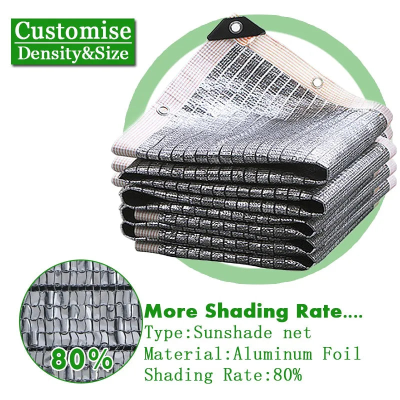 Silvery aluminum foil sunshade net, folded with grommets; 80% shading rate.