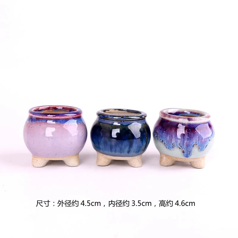Set of three mini ceramic succulent flowerpots, pink, dark blue, and purple crackle glaze.
