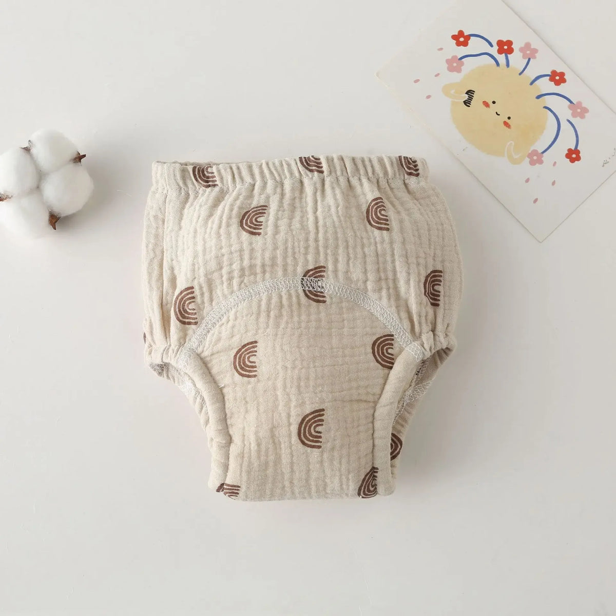 Beige muslin baby training diaper with brown rainbow print for comfortable potty training.