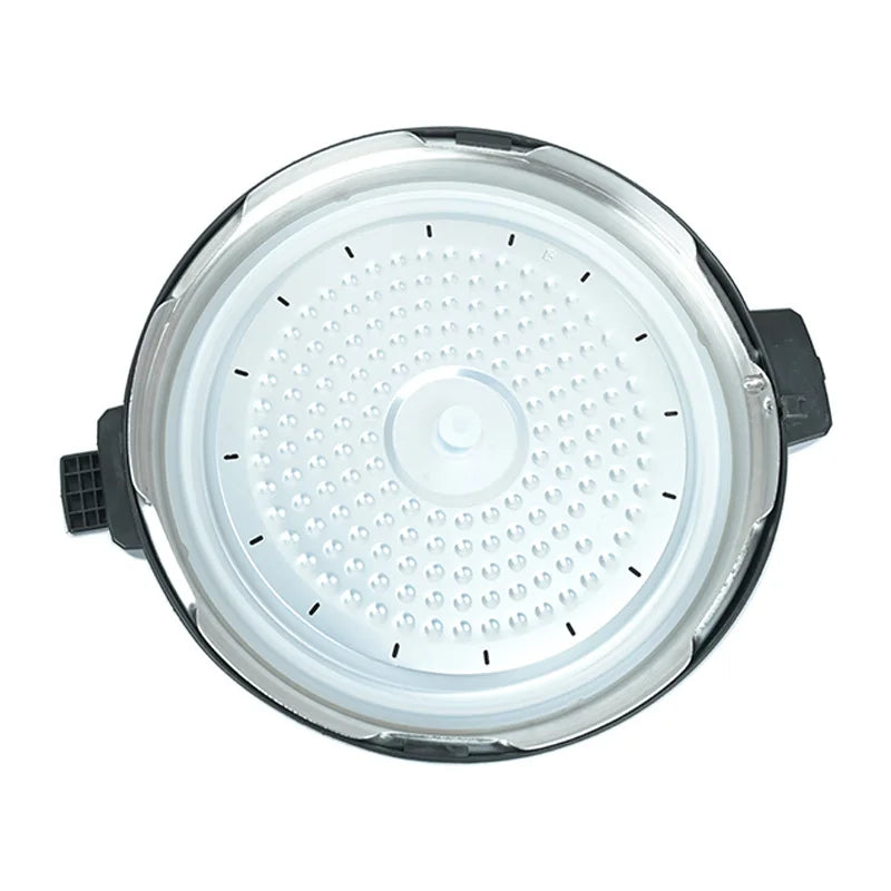 Pressure cooker lid with white perforated steam plate and central release valve