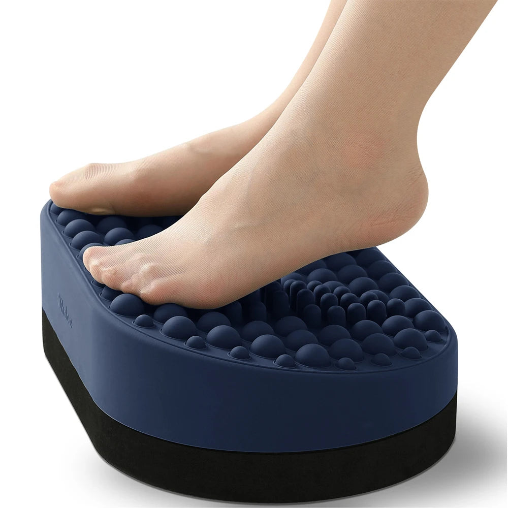 Blue silicone foot rest for desk with textured massage nodes under feet for plantar fasciitis relief and ergonomic aid.