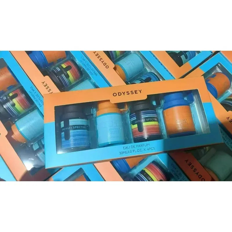 Odyssey Spectra eau de parfum set of four 30ml small glass spray bottles in a bright orange and blue cardboard box.