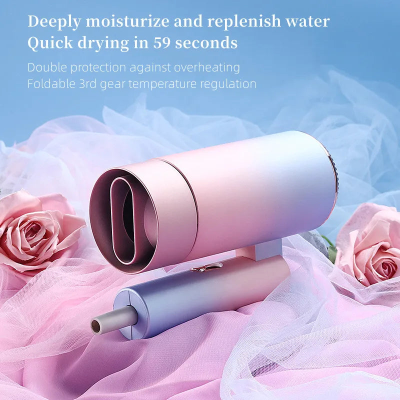 Foldable ionic mini hair dryer in ombre pink-blue with sleek nozzle, featuring quick-dry tech and 3 heat settings.