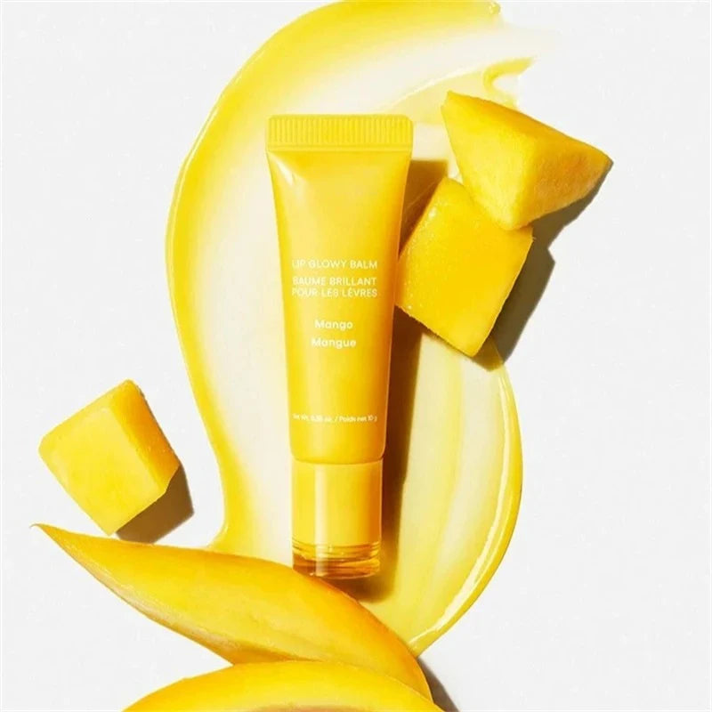 Laneige Mango Lip Glowy Balm in yellow tube with glossy serum texture and fresh mango fruit slices.
