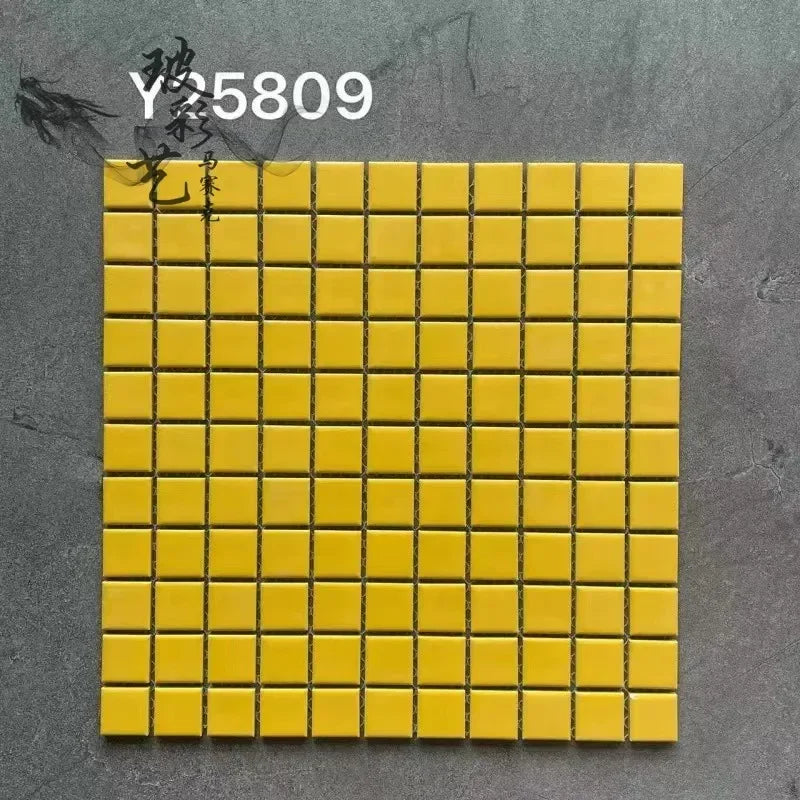 Ceramic mosaic tile sheet with small square mustard yellow tiles on grid backing